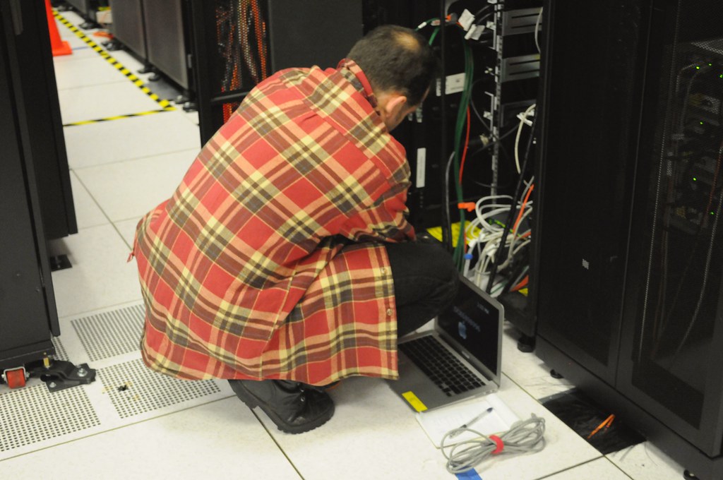 Technician reviewing equipment in a server environment